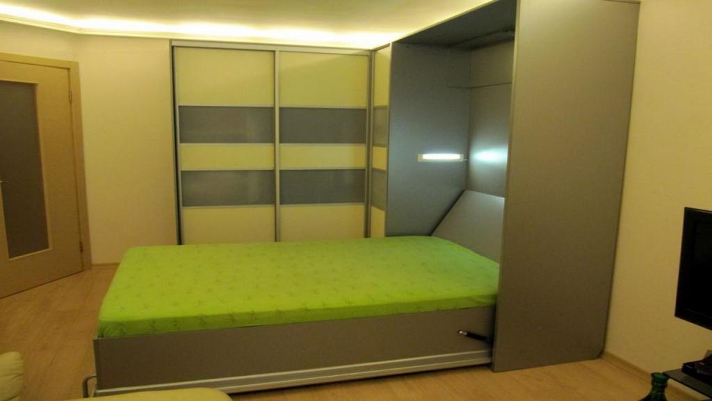 contemporary-bed-invisible-design-on-closet-with-green-bedding-set-along-with-led-lighting-idea-in-bedroom-ceiling-as-well-wooden-floor